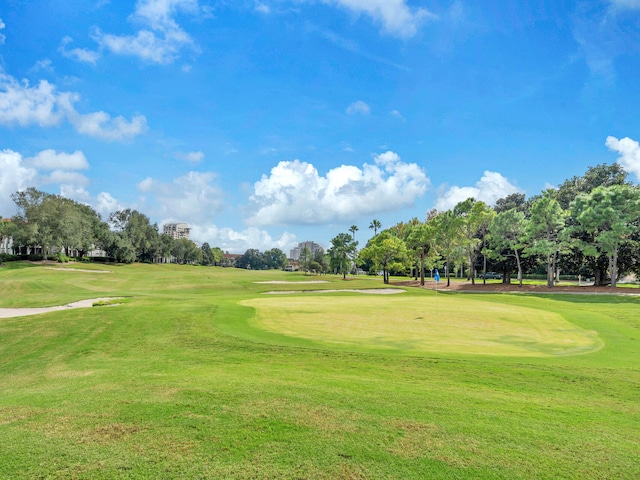 view of property's community featuring golf course view and a yard