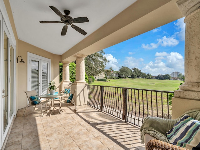 balcony with a ceiling fan, golf course view, and french doors