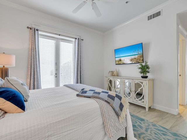 bedroom with light wood-type flooring, ceiling fan, and crown molding