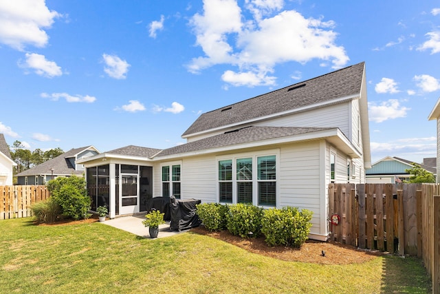 back of house featuring a lawn and a patio area