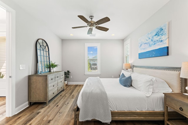 bedroom with ceiling fan and wood-type flooring