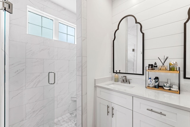 bathroom featuring vanity, wooden walls, and walk in shower