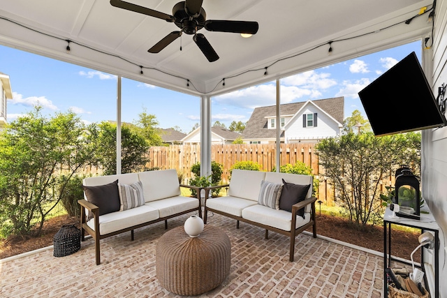 sunroom featuring ceiling fan