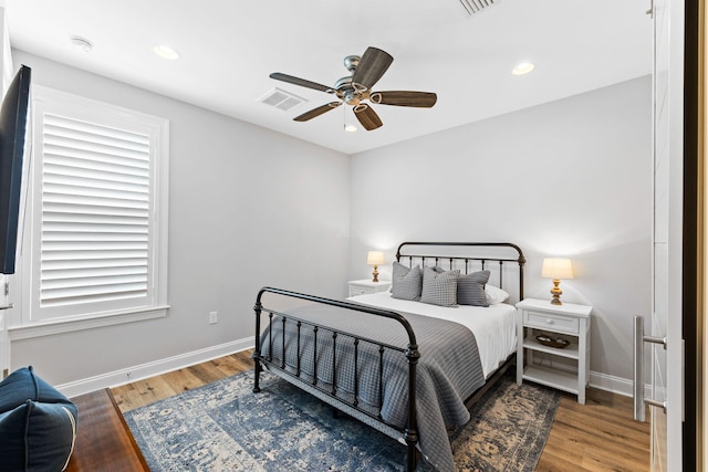 bedroom with wood-type flooring and ceiling fan