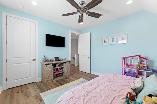 bedroom featuring light wood-type flooring, lofted ceiling, and ceiling fan