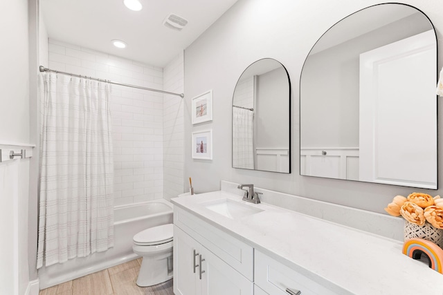 full bathroom featuring vanity, toilet, hardwood / wood-style flooring, and shower / bath combo with shower curtain