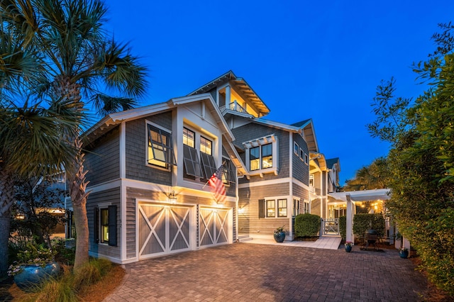 view of front facade with decorative driveway and a garage