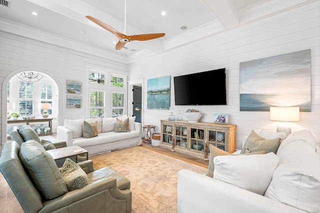 living room featuring ceiling fan, beam ceiling, and ornamental molding