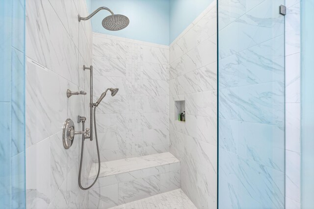 bathroom with a tile shower