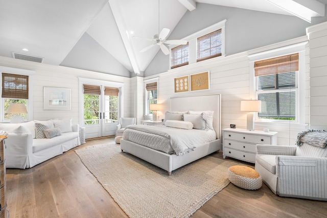 bedroom featuring hardwood / wood-style flooring, beamed ceiling, high vaulted ceiling, and ceiling fan