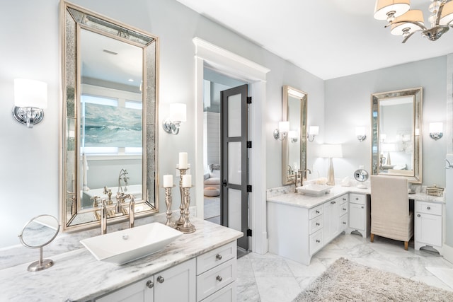 bathroom with a notable chandelier and vanity