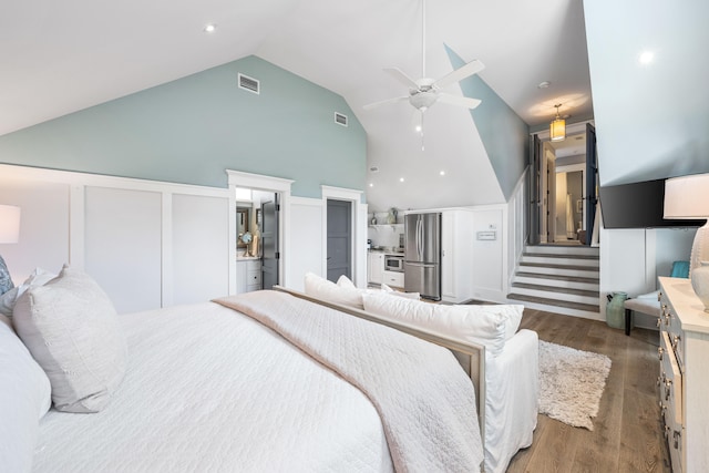 bedroom with dark wood-type flooring, high vaulted ceiling, stainless steel refrigerator, and ceiling fan