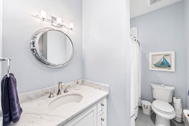 bathroom featuring vanity, toilet, a shower with curtain, and tile patterned floors