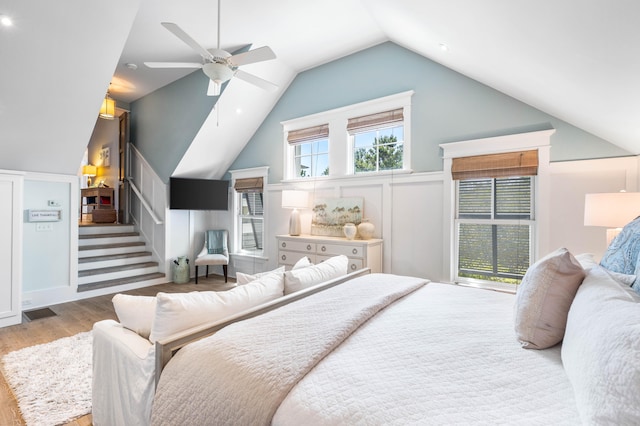 bedroom featuring lofted ceiling, ceiling fan, and light hardwood / wood-style floors