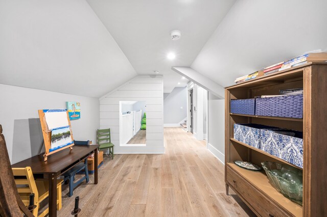 additional living space with lofted ceiling and light wood-type flooring