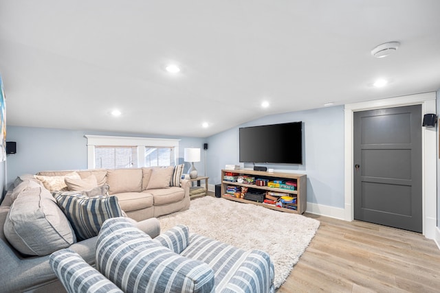 living room featuring vaulted ceiling and light hardwood / wood-style flooring