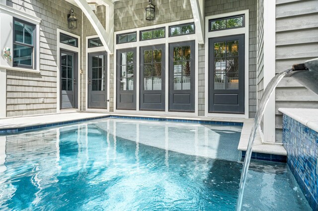 view of swimming pool with pool water feature