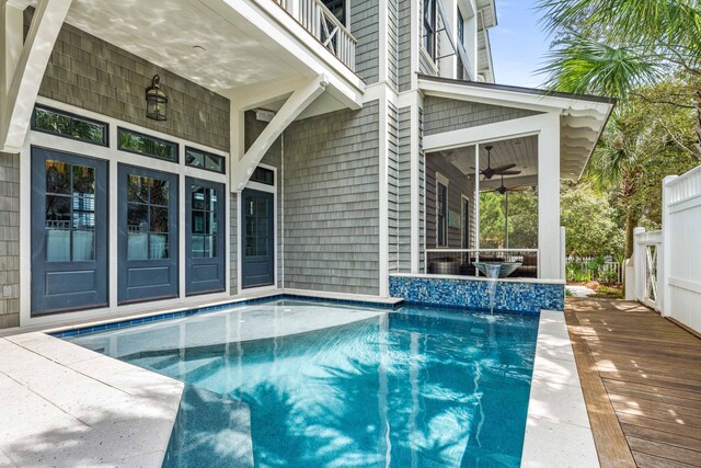 view of swimming pool featuring ceiling fan