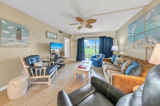 tiled living room with ceiling fan