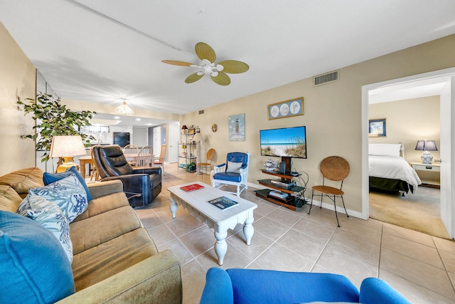 living room with ceiling fan and light tile patterned floors