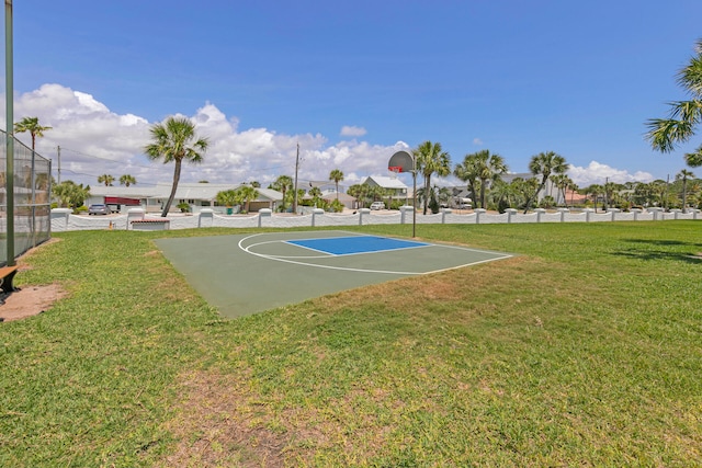 view of basketball court with a yard