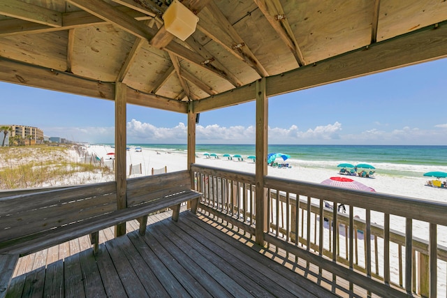 deck featuring a beach view and a water view