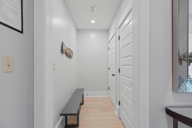 hall featuring visible vents, recessed lighting, light wood-type flooring, and baseboards