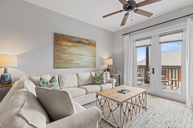 living area featuring light wood-style flooring and ceiling fan