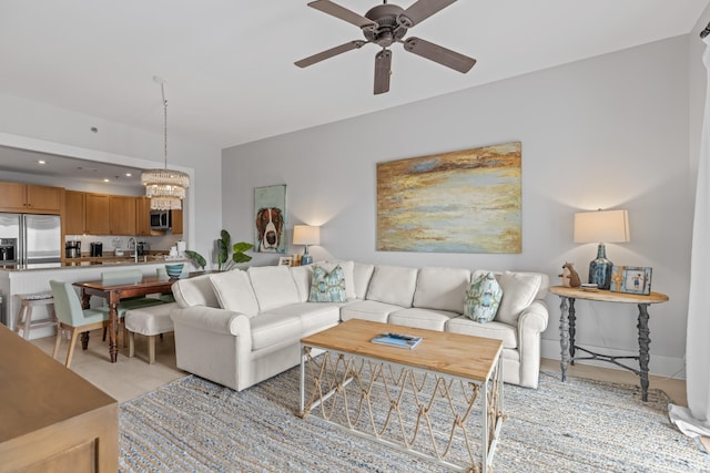 living room with ceiling fan with notable chandelier