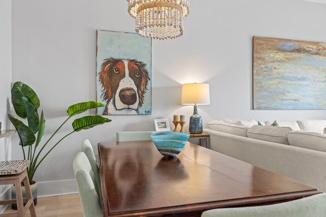 dining area featuring an inviting chandelier and wood finished floors