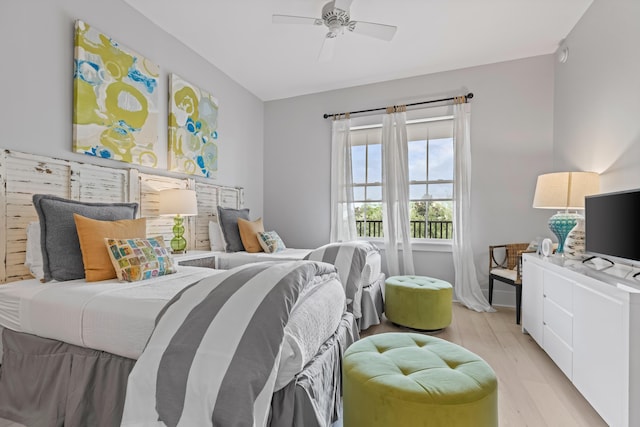 bedroom with light wood finished floors and a ceiling fan