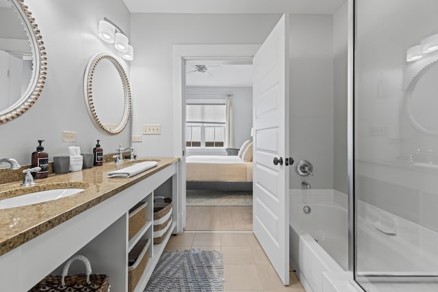 ensuite bathroom with tile patterned flooring, ensuite bathroom, a ceiling fan, and a sink