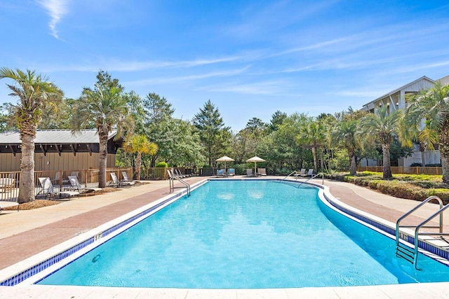 community pool featuring a patio and fence