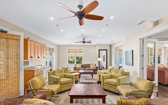 living area with recessed lighting, visible vents, and ceiling fan