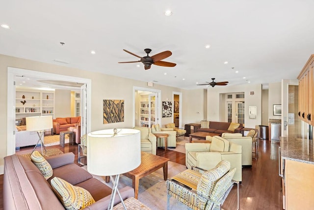 living area featuring recessed lighting, dark wood-style floors, built in shelves, and ceiling fan