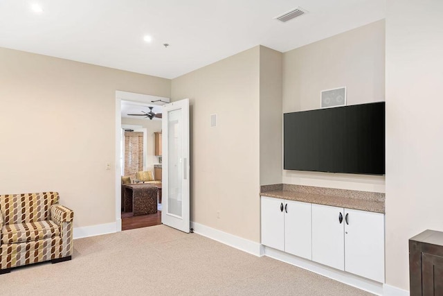 unfurnished room featuring a ceiling fan, visible vents, baseboards, recessed lighting, and light carpet