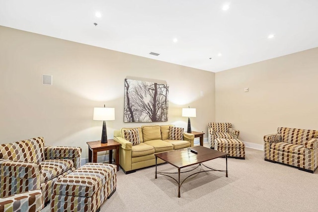 living room featuring recessed lighting, visible vents, and light carpet