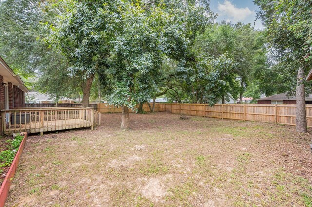 view of yard featuring a wooden deck