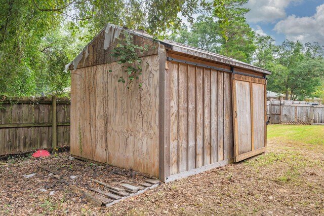 view of outbuilding with a lawn