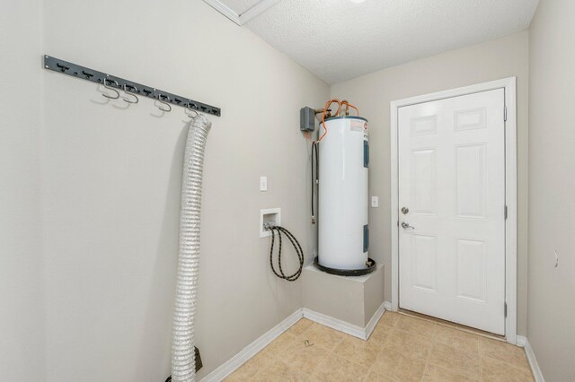 washroom featuring hookup for a washing machine, a textured ceiling, and water heater