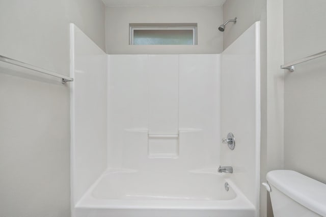 bathroom featuring toilet and tub / shower combination