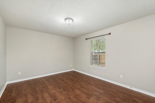 unfurnished room featuring a textured ceiling and dark wood-type flooring