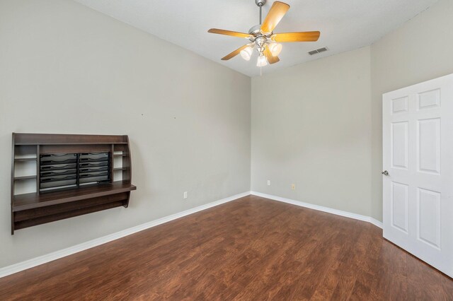 unfurnished living room with dark wood-type flooring and ceiling fan