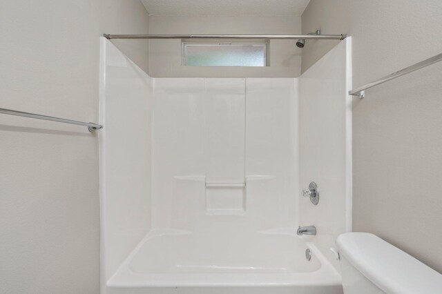 bathroom with toilet and washtub / shower combination