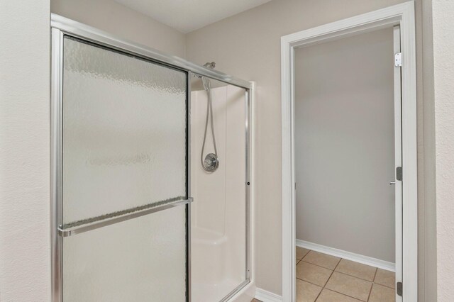 bathroom featuring tile patterned flooring and walk in shower