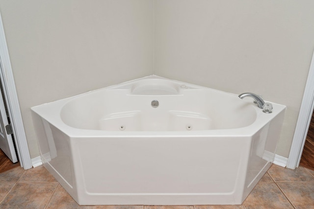 bathroom with a tub and tile patterned floors