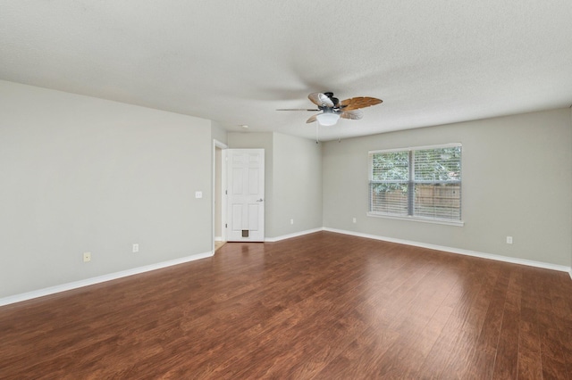 unfurnished room with baseboards, a textured ceiling, dark wood finished floors, and a ceiling fan