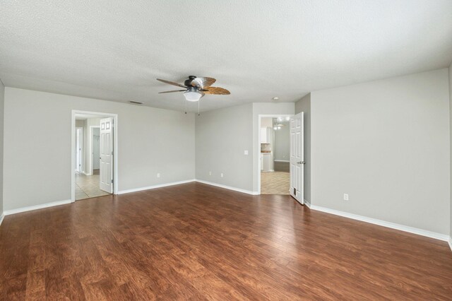 unfurnished room featuring hardwood / wood-style floors, ceiling fan, and a textured ceiling