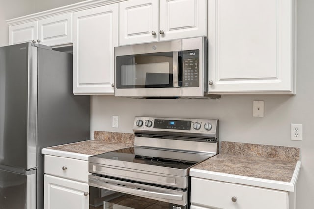 kitchen with stainless steel appliances and white cabinets