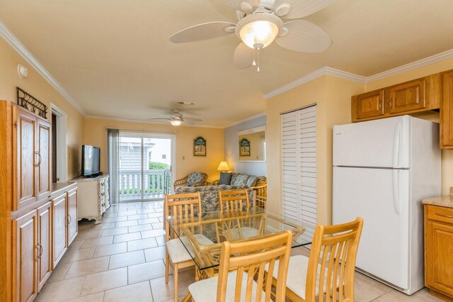 dining space with ceiling fan, light tile patterned floors, and ornamental molding